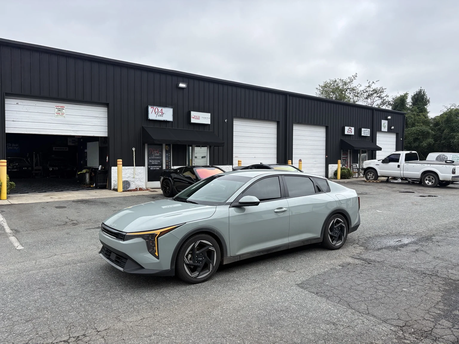 Kia K4 with tinted side windows parked outside 704Tint