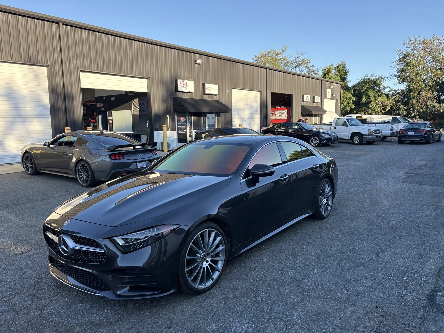 Mercedes CLS 450 with Sunset Red chameleon tint outside the 704Tint shop